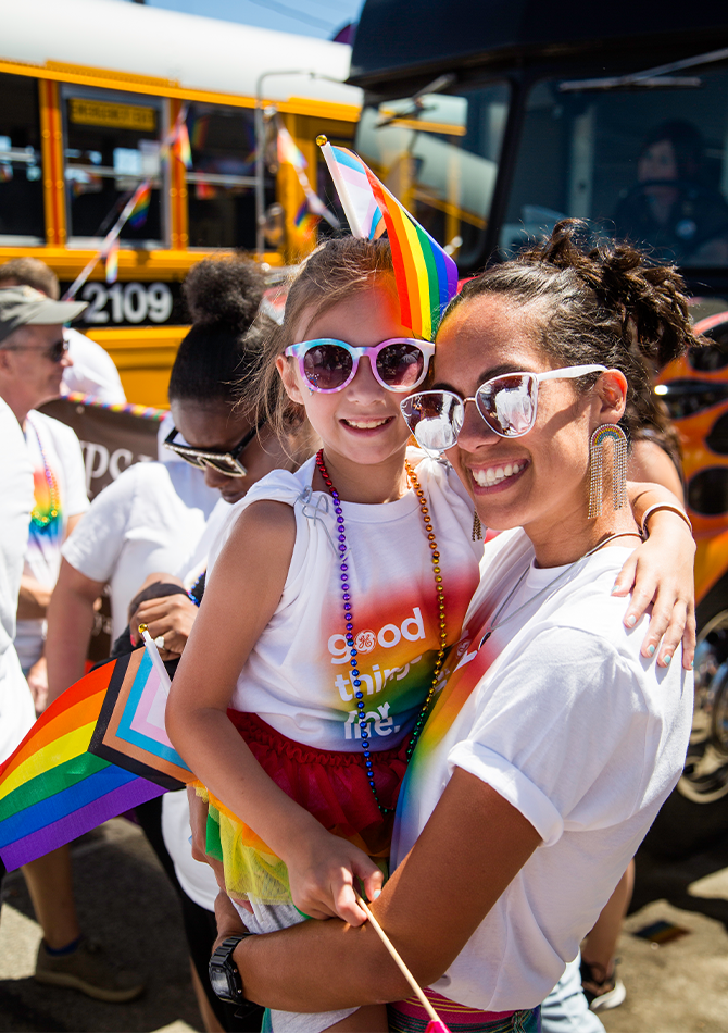 Detail image of a child with their parent for June 2023 Celebrating Pride story.